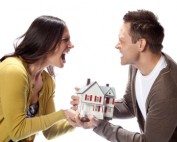 Modern couple negotiating home sale with real estate agent in bright setting.