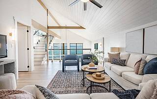 Professionally staged open-concept living room with vaulted ceiling and neutral decor for a Colorado Western Slope home sale