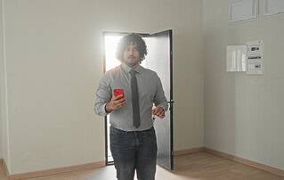 Homebuyer with clipboard performing a final walkthrough checklist inside a Grand Junction home before closing.