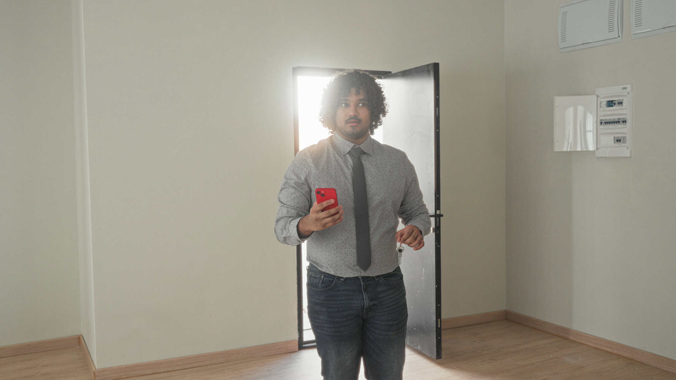 Homebuyer with clipboard performing a final walkthrough checklist inside a Grand Junction home before closing.