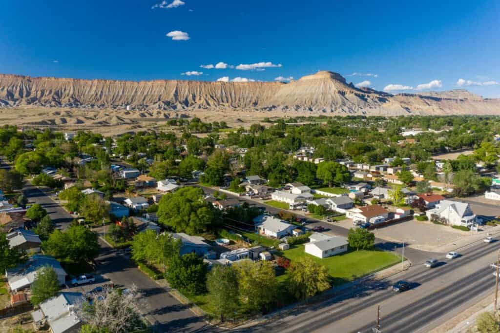 Aerial view of Grand Junction, Colorado neighborhoods with the Colorado National Monument in the background
